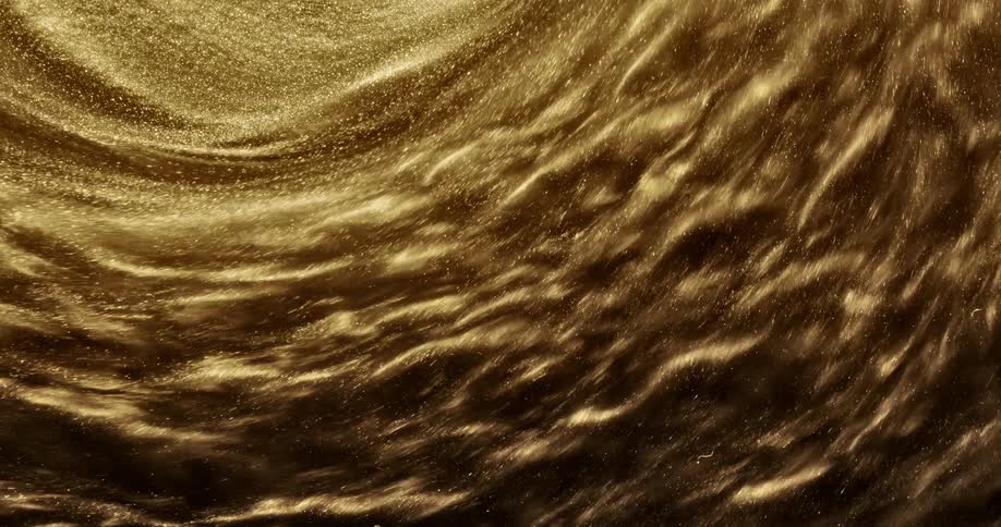 Gold glitter shimmers as it spins in a centrifuge
