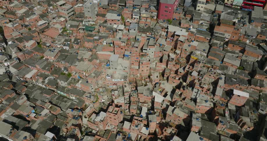 Houses and larger buildings are packed closely together in a city