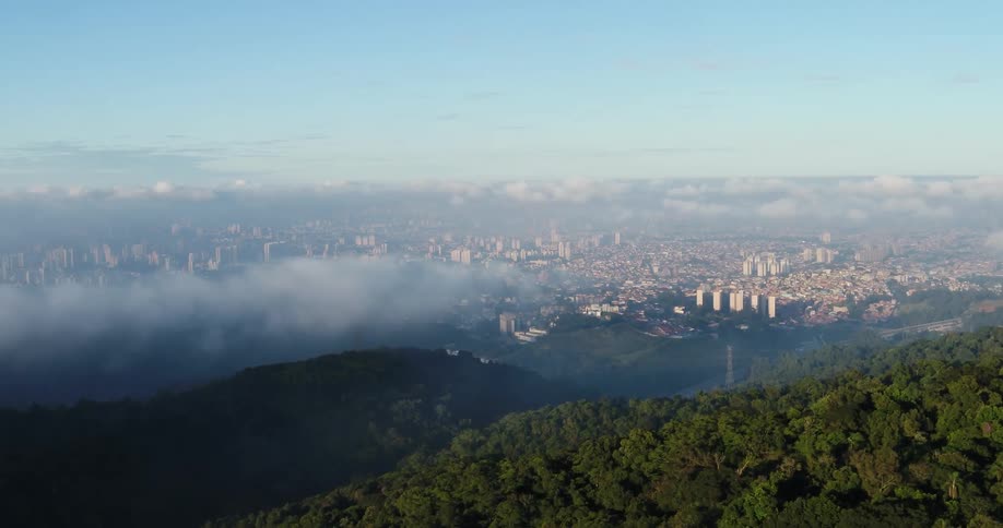 Tree covered mountain ridges above a city in the valley