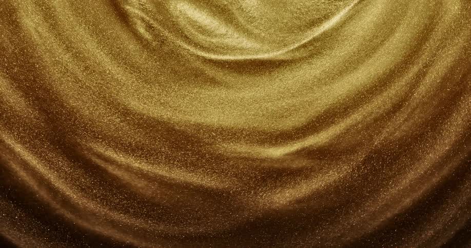 Golden glittering particles swirl around in a circular motion