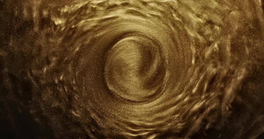 Golden grains of sand swirls in circle
