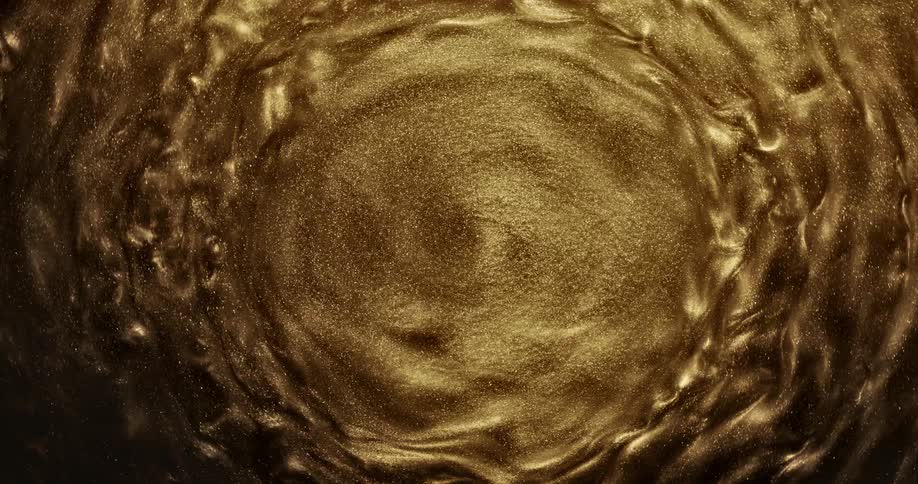 Gold waves shimmering and spinning in circles around a glitter center
