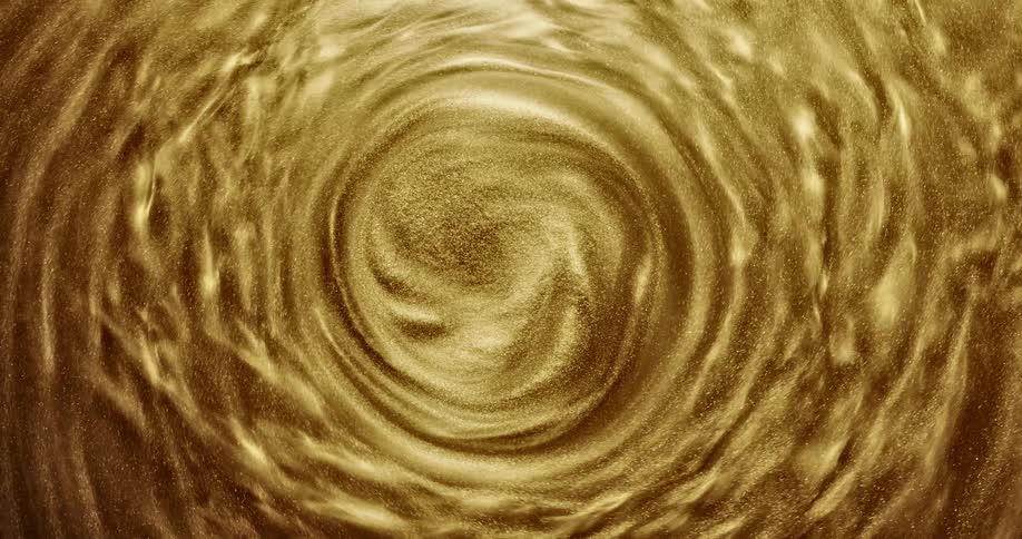 A viscous gold fluid moves in a centrifuge
