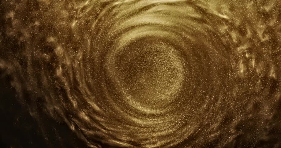 Shimmering gold fluid spins in a spiral pattern