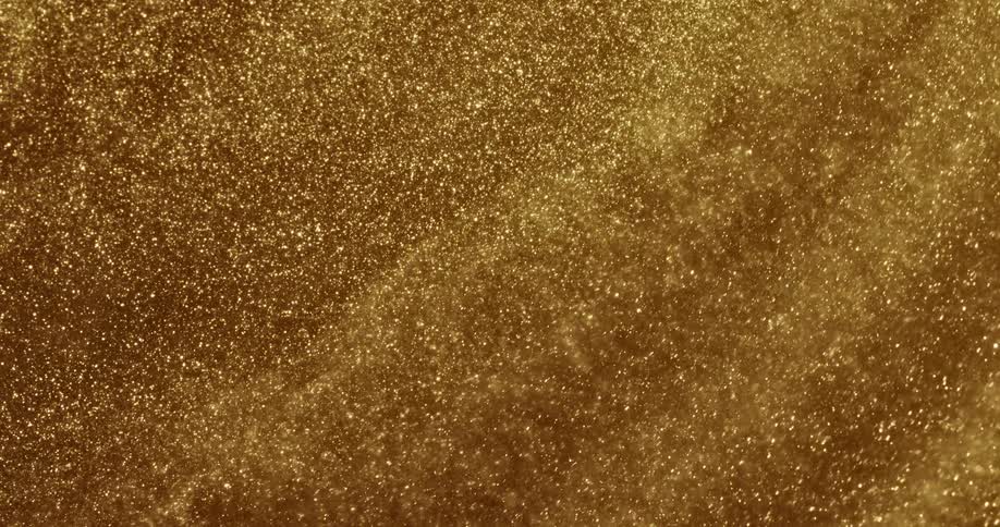 Golden grains of sand swirl