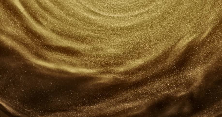 Gold shimmering fluid spins in a circle