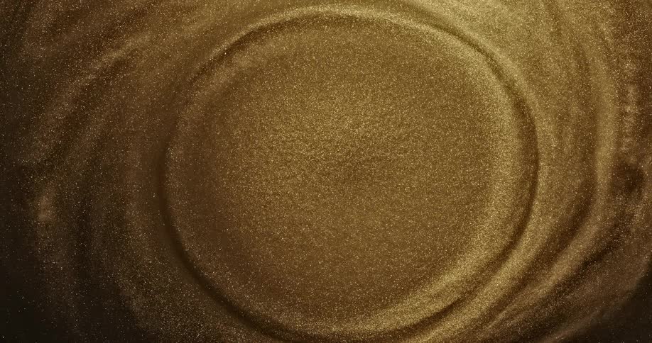 Shimmering gold liquid spins in a circle pattern
