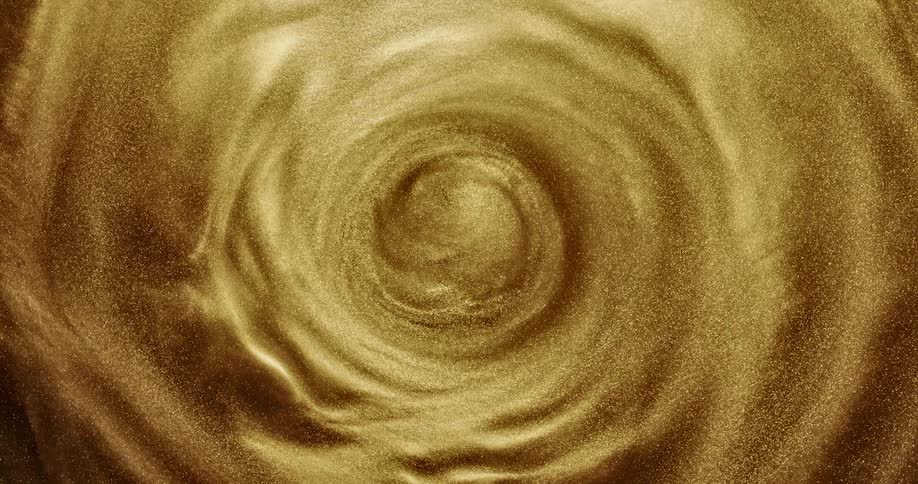 A shimmery gold fluid spins in a centrifuge