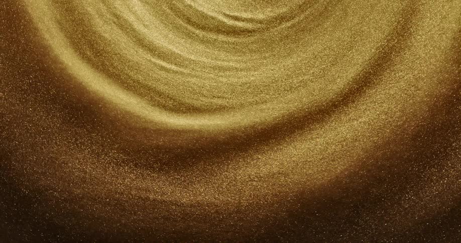 A glittering gold substance sparkles as it moves and swirls