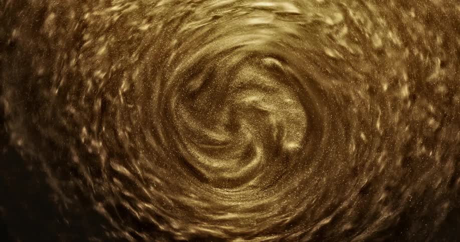 A shimmering gold liquid spins faster in a centrifuge