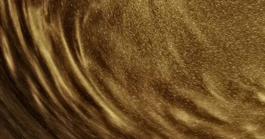 A glittering gold substance sparkles as it moves and swirls