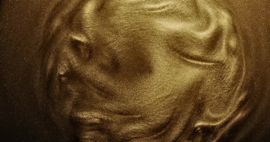 Mass of golden particles flow and slowly swirl