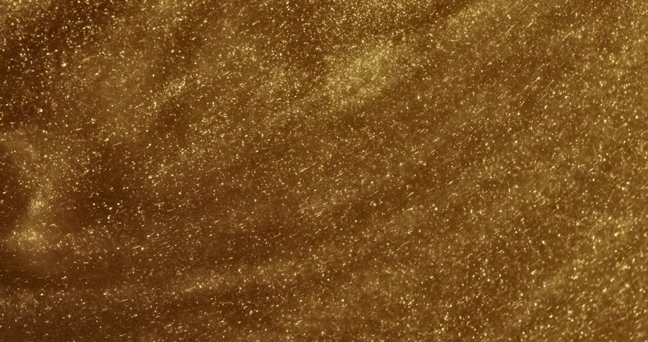Golden grains of sand swirl in the circle