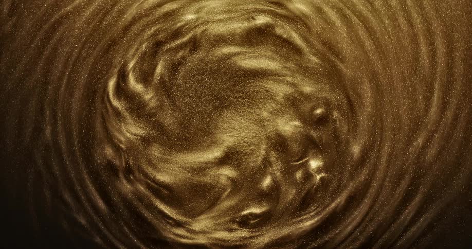 Golden grains of sand swirl