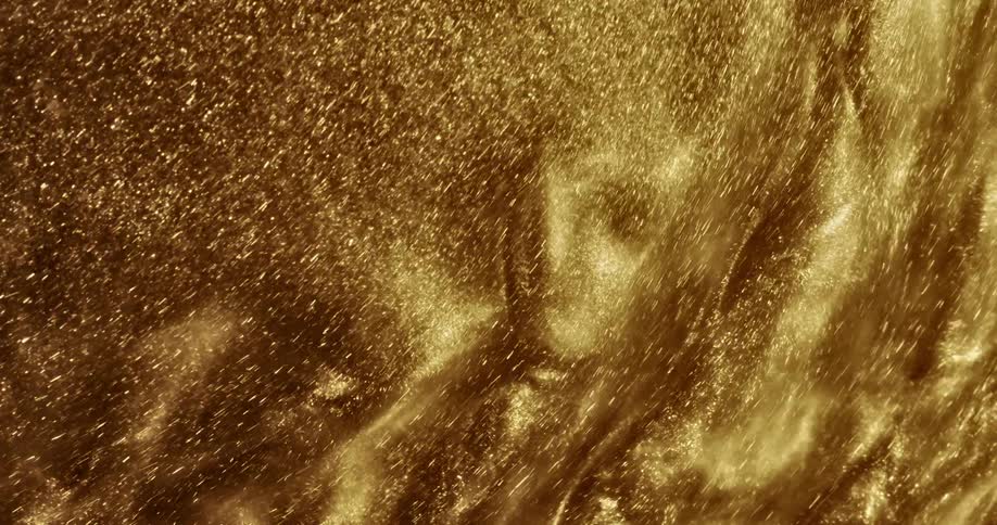 Golden glitter swirls round quickly and makes rippling patterns and whorls