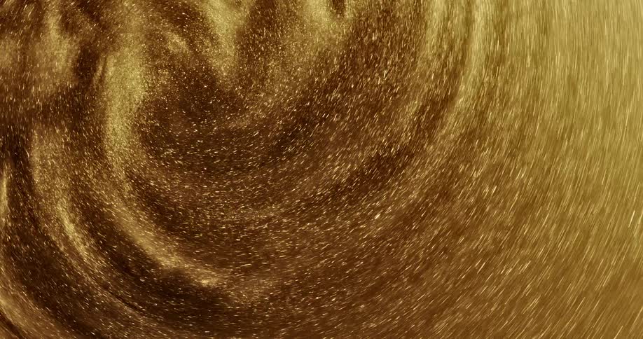 Bright shiny glittering gold ink slowly spinning in concentric waves and ripples
