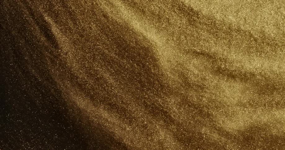 Bright shiny glittering gold ink slowly spinning in concentric waves and ripples