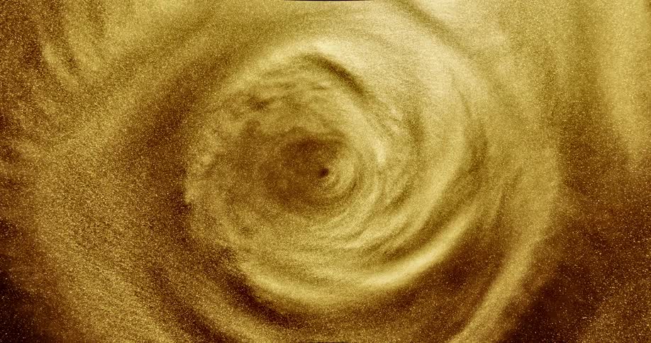 A shimmering gold fluid moves in a spiral