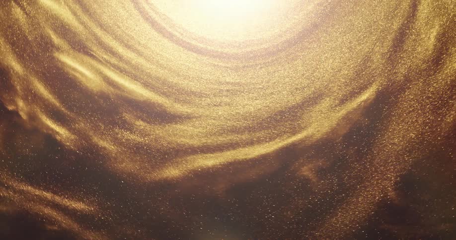 Gold sand spins and flows around bright center forming shadowy lumps on the outer ring