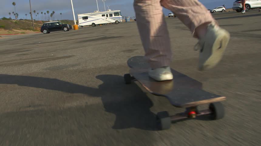 There is some skateboarding outside in the middle of the daytime