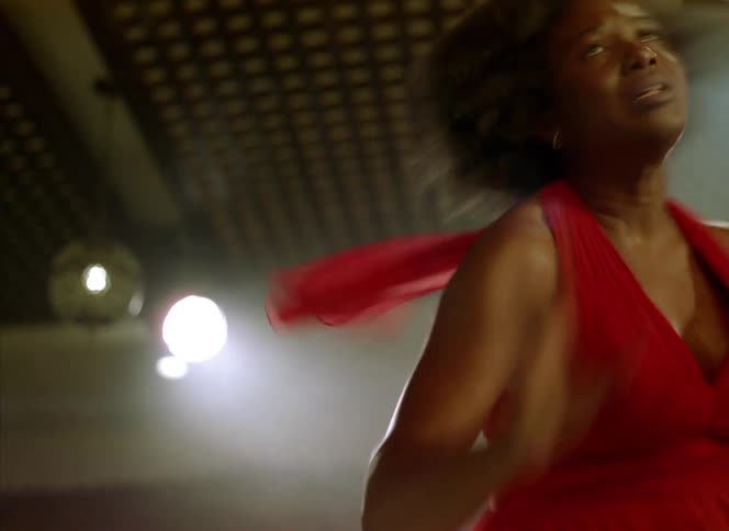 A woman dances indoors