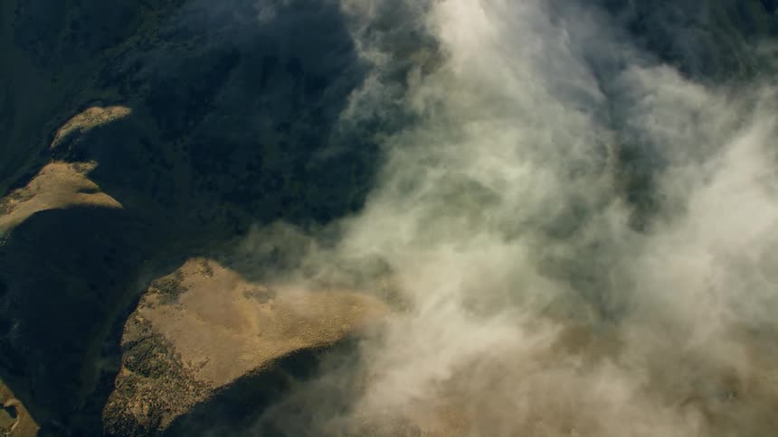 Clouds floating above mountain ridges