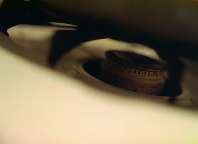 A pot cooks on a gas stove
