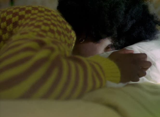 A woman is sleeping in her bed during the morning