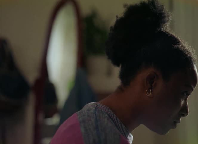 A woman greets someone with a big smile then turns her head away in anger