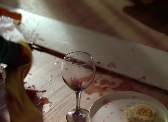 A woman gets mad and knocks a glass of wine over on a laptop then picks up the laptop and walks away