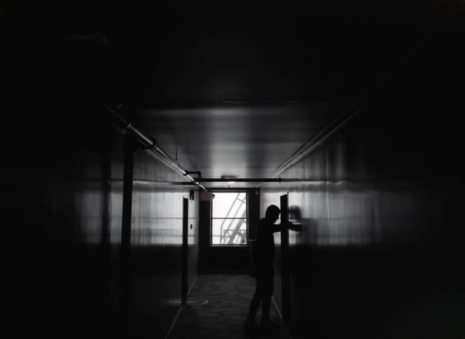 A person is knocking on a door in an apartment