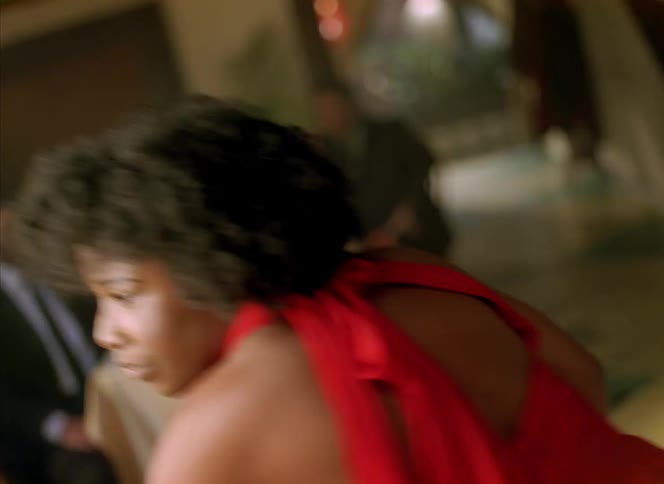 A woman is in a red dress and barefoot dancing