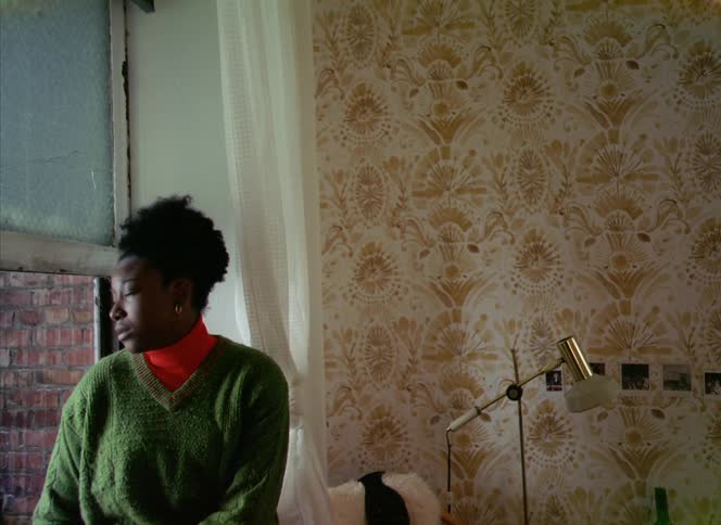 A woman poses while perched on her window ledge