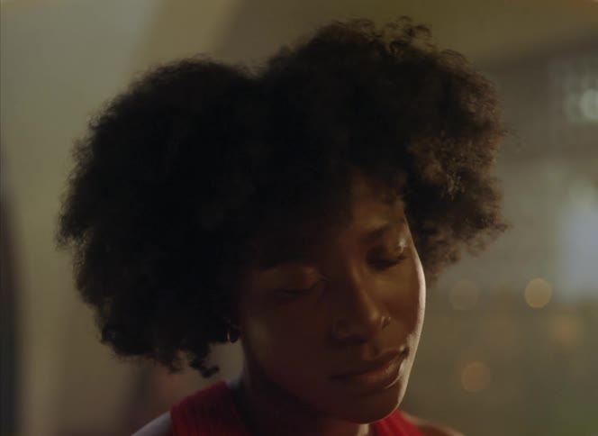 A woman with her eyes closed and head back swaying to music