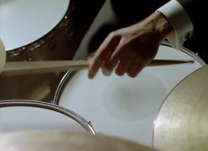 A man playing drums in a room