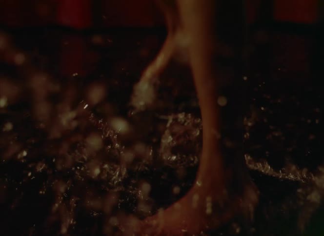 A woman is dancing in a puddle of water