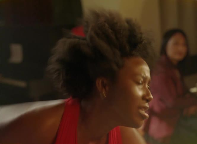 A woman is performing an intense dance