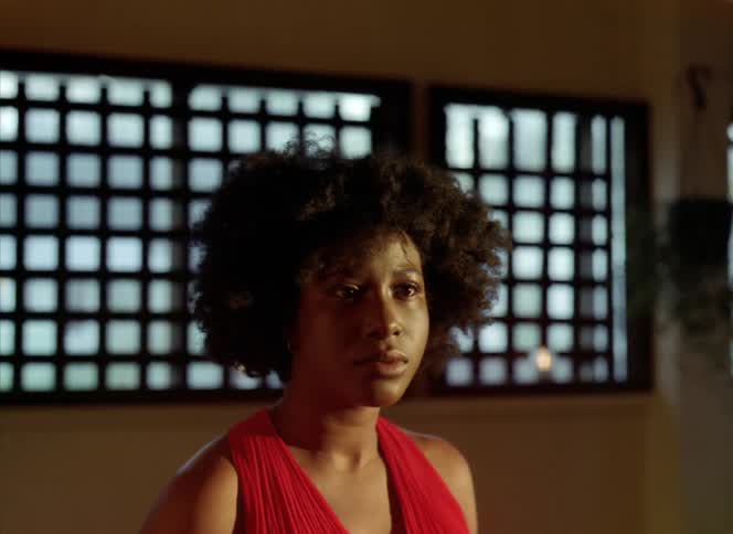 Close up of the face of a confused woman looking around a room apprehensively