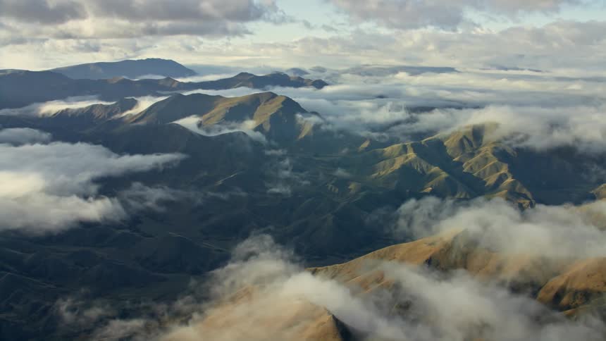 Aerial view of mountainous area under clouds