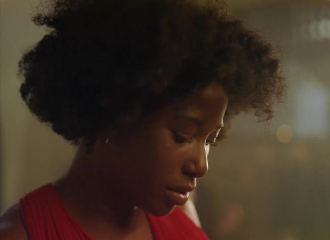 Close up of the face of a woman feeling the rhythm and starts dancing inside a restaurant