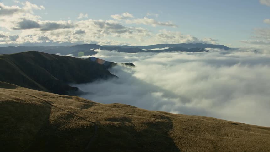 An aerial view of mountains on a cloudy day