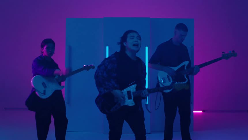 A group of people playing in a band on stage