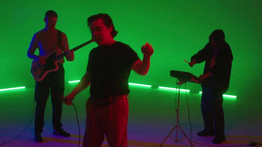 A band is on a smoky stage performing