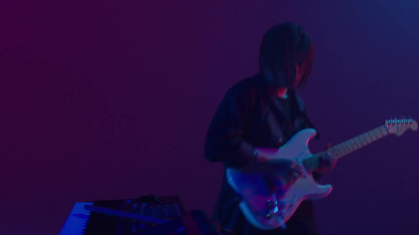 Two members of a band performing together both dancing as they play music