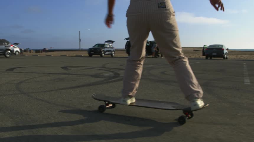 A woman riding a longboard outdoors