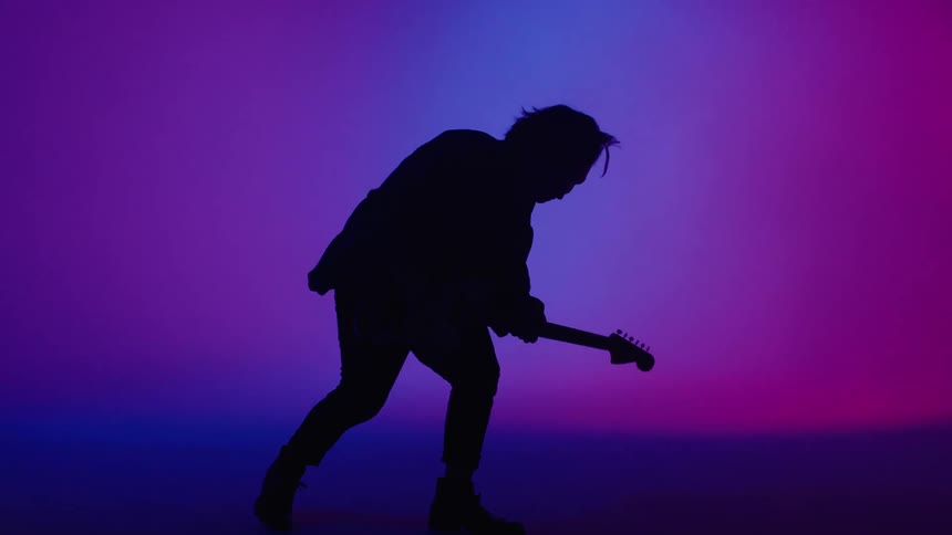 A guitarist playing music on a stage