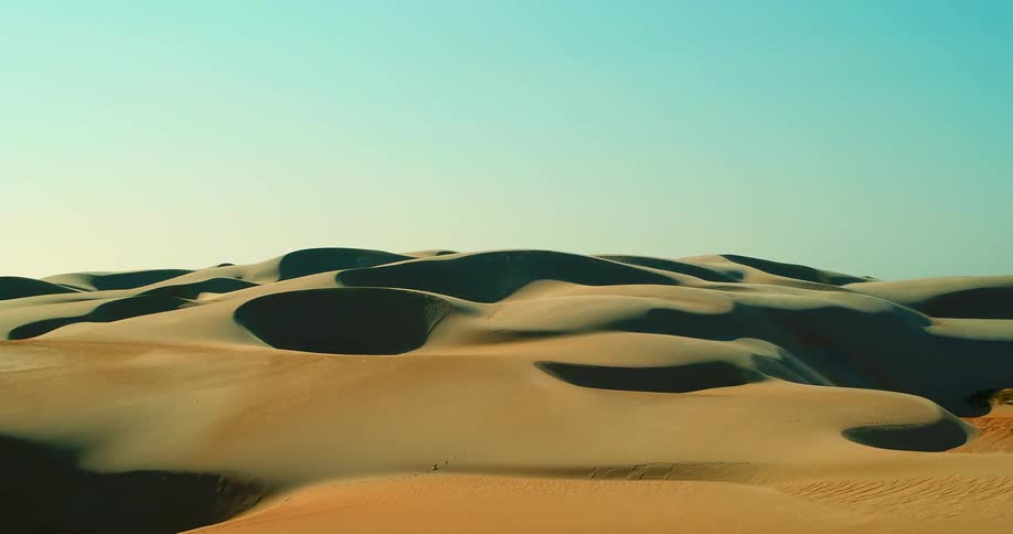 An aerial view of sand dunes in a desert