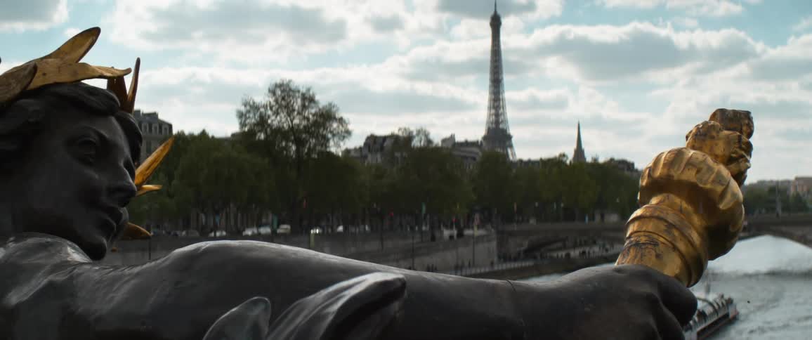 A large sculpture sits within view of the eiffel tower