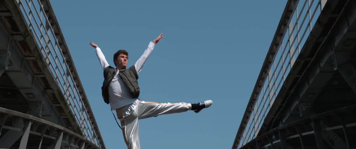 A man dancing and jumping outdoors