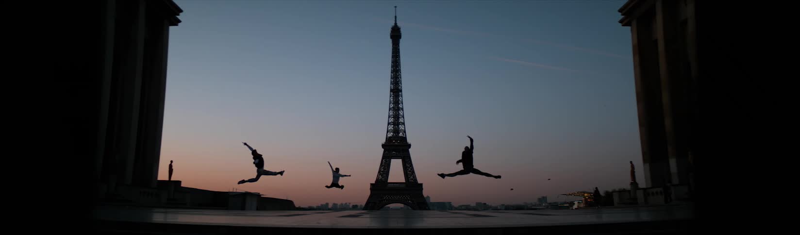 People jump and dance at sunset